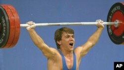 Turkey's Naim Suleymanoglu, seen in this 1988 file photo, died Saturday, Nov. 18, 2017. He was considered one of the sport's greatest athletes and earned his nickname for his strength and diminutive size. 