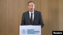 FILE - Britain's MI6 chief Alex Younger speaks at MI6's Vauxhall Cross headquarters in central London, Britain, in this still image from video, Dec. 8, 2016.