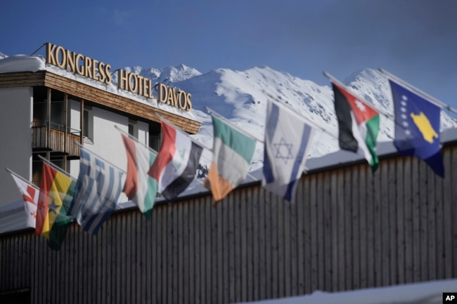 International flags wave on top of the Davos Congress Center where the World Economic Forum takes place in Davos, Switzerland, Monday, Jan. 15, 2024.(AP Photo/Markus Schreiber)