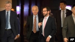 FILE - White House trade adviser Peter Navarro (2nd-L) leaves his hotel in Beijing for trade negotiations with Chinese officials, May 4, 2018. 