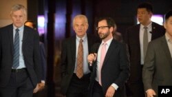 FILE- White House trade adviser Peter Navarro (2nd-L) leaves his hotel in Beijing for trade negotiations with Chinese officials, May 4, 2018. 