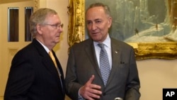 FILE - Then-Senate Majority Leader Mitch McConnell, left, talks with then-Minority Leader Chuck Schumer on Capitol Hill in Washington, April 13, 2016.