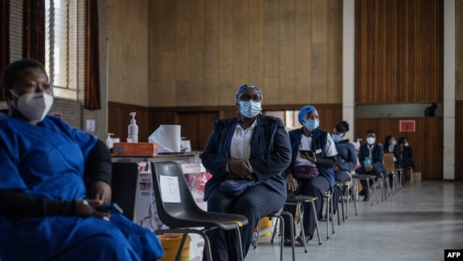 Health care workers await doses to start vaccinating people with Pfizer vaccines at the Bertha Gxowa Hospital in Germiston, South Africa, May 17, 2021.