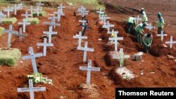 FILE - Workers prepare new graves at the Christian burial area provided by the government for victims of the coronavirus disease at Pondok Ranggon cemetery complex in Jakarta, Indonesia, Sept. 16, 2020. 