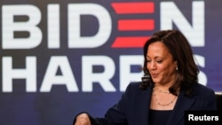 Democratic U.S. vice presidential candidate Senator Kamala Harris signs official documents needed to receive her party's official nomination next week during an event in Wilmington, Delaware, Aug. 14, 2020. 