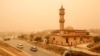FILE—Motorists drive their vehicles through a sandstorm in Libya's eastern city of Benghazi on April 22, 2024.