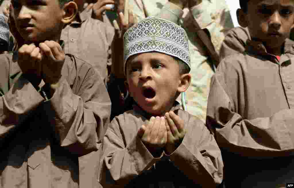 A Muslim boy reacts as he takes part in a special prayer for better rainfall, in Mumbai, India.