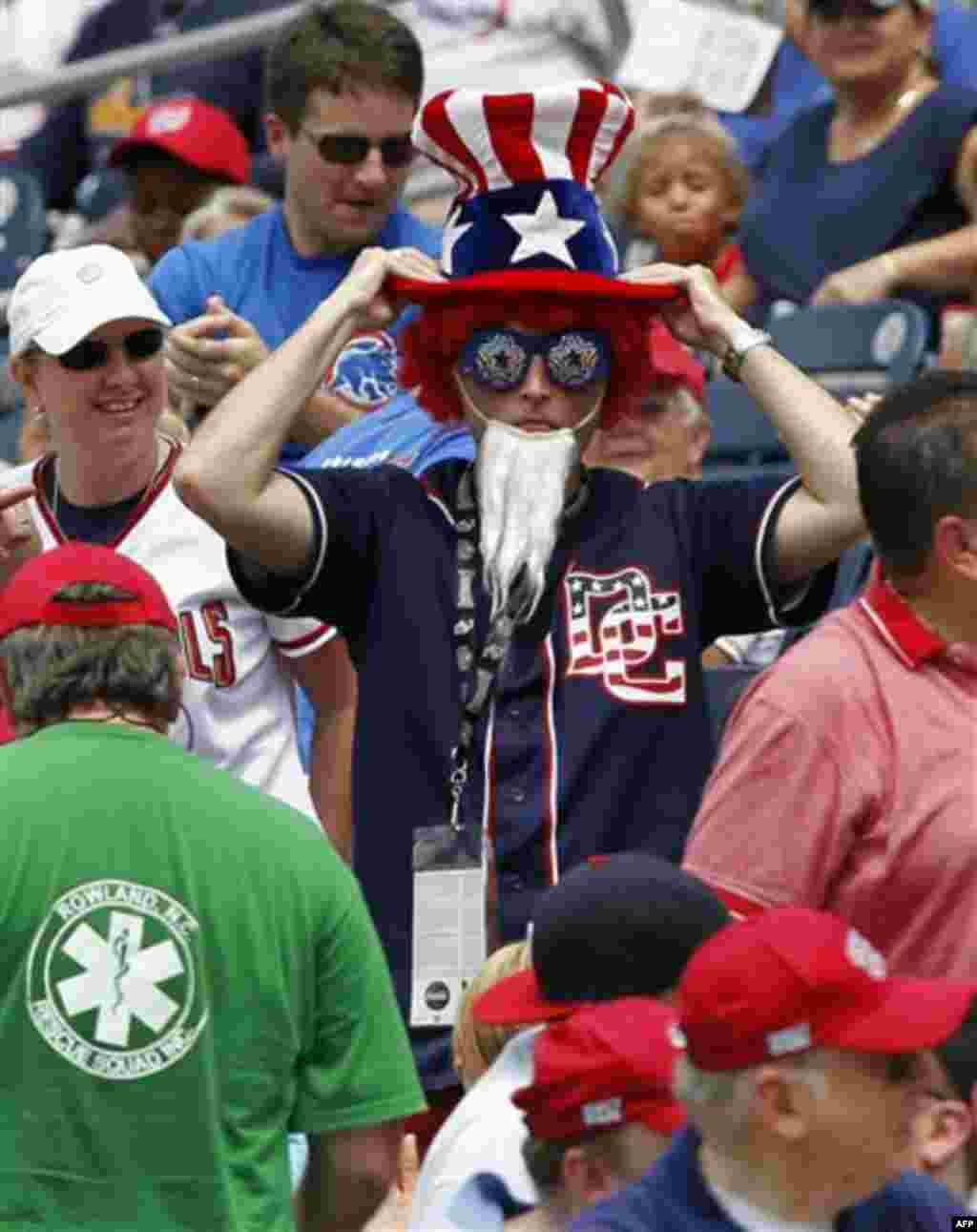 A fan adjusts his hat during the Washington Nationals-Chicago Cubs baseball game at Nationals Park on Monday, July 4, 2011 in Washington. The Nationals won 5-4 in 10 innings. (AP Photo/Alex Brandon)