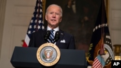 President Joe Biden delivers remarks on climate change and green jobs, in the State Dining Room of the White House, Wednesday, Jan. 27, 2021, in Washington. (AP Photo/Evan Vucci)