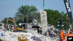 Search and rescue crews work at the site of the collapsed Champlain Towers South condo building after the remaining structure was demolished, in Surfside, Florida, July 5, 2021. 