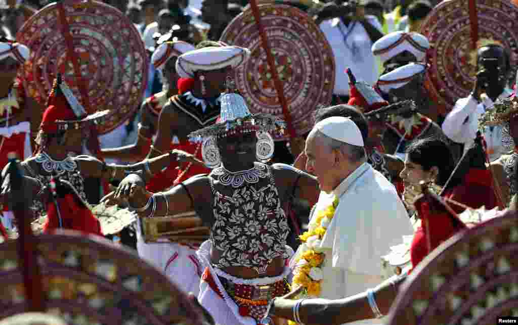 Pope Francis is greeted as he arrives at the Colombo Airport, Sri Lanka, Jan. 13, 2015.