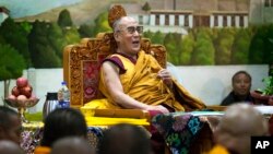 Tibetan spiritual leader the Dalai Lama laughs during his annual teaching for Tibetan school and college students at the Tibetan Children's Village School in Dharmsala, India, June 4, 2014. 