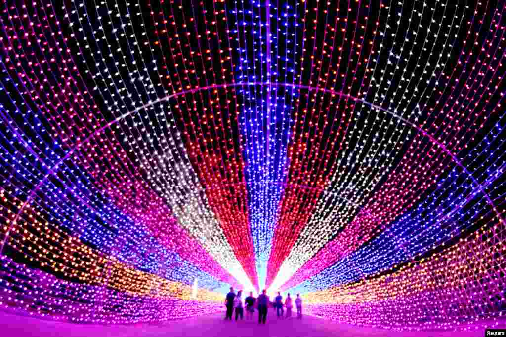 Tourists walk through a lantern installation in Zhangjiakou, Hebei Province, China, July 4, 2016.