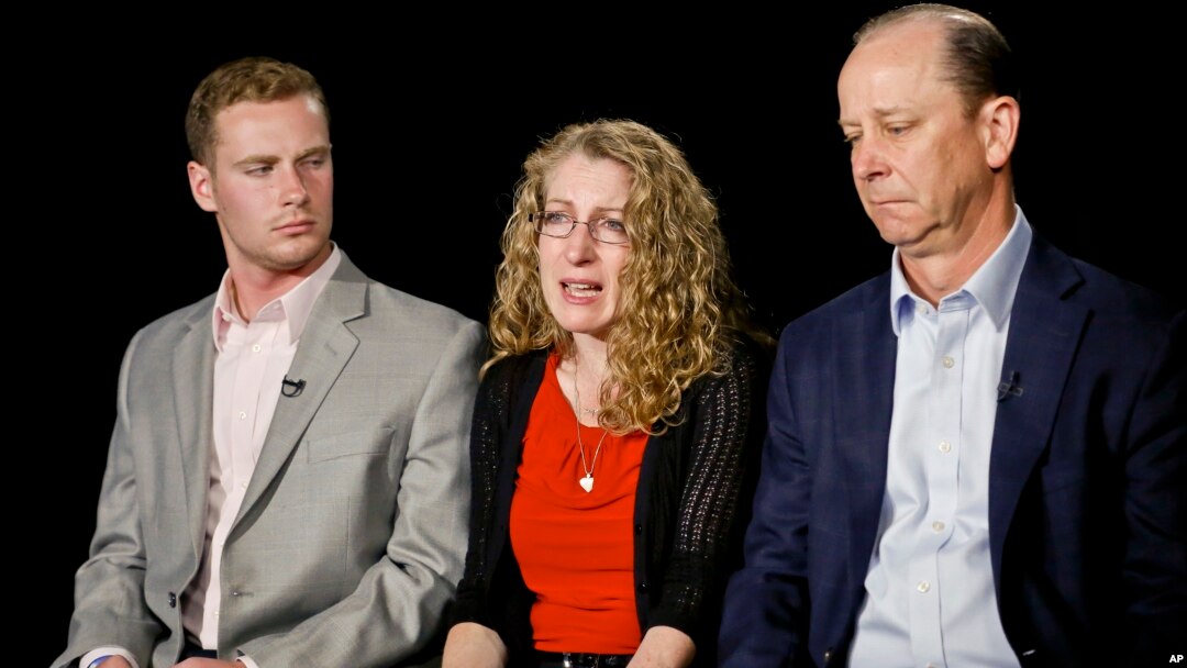 FILE - Evelyn Piazza, center, seated with her husband Jim, right, and son Michael, speaks during an interview May 15, 2017, in New York. The Piazzas talked about Tim Piazza, 19, a brother, son and Penn State sophomore who died in February after he was put through a hazing ritual at his fraternity house and forced to drink dangerous amounts of alcohol in a short amount of time.