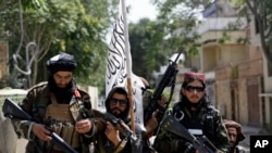 Taliban fighters display their flag as they patrol in Kabul, Afghanistan, Aug. 19, 2021. 