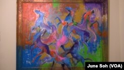 Ahmad Alkarkhi has started painting with a whole new color palette since he came to the U.S. These colorful horses represent refugees who come from all over and work and live together.