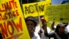 FILE - Demonstrator show their placards during climate change protest outside the Johannesburg Stock Exchange in Johannesburg, South Africa, Nov. 29, 2019. 