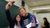 FILE - A couple takes a selfie while voting in Mataro, near Barcelona, Spain, Nov. 9, 2014. In the United States, various states are weighing whether to allow "I Voted" selfies in the ballot booth.