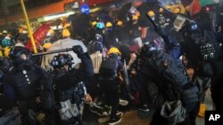 Policemen using batons charge on protesters during a rally in Hong Kong, July 28, 2019.