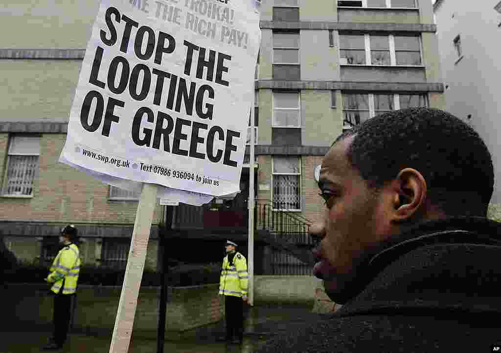 Demonstrators protest in solidarity with demonstrators and protestors in Greece, outside the Greek Embassy in London February 18, 2012. (Reuters)