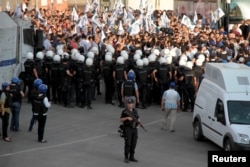 Turkish riot police surround demonstrators during a protest against the latest security operations in Diyarbakir, Turkey, Sept. 6, 2015.