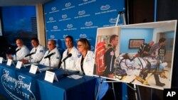 A photo of a patient being transported is displayed while medical staff at Henry Ford Hospital answer questions during a news conference in Detroit, Tuesday, Nov. 12, 2019. 