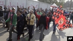 Fans from Al Ahly and Al Zamalek soccer teams chant slogans against the violence that occurred during a soccer match involving Al Ahly in Port Said, February 2, 2012