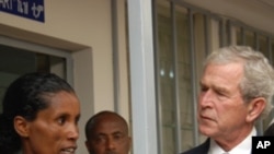 President Bush listens to an HIV positive mother explain how she has learned to keep her baby HIV free.