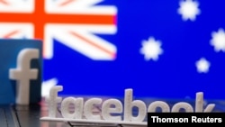 A 3D printed Facebook logo is seen in front of displayed Australia's flag in this illustration photo, Feb.19, 2021.