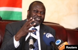 FILE - South Sudan's rebel leader Riek Machar addresses a news conference. After two years of civil war, rebel leader Machar and South Sudan President Salva Kiir signed a peace deal in August.