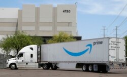 FILE - An Amazon shipping truck is seen at a fulfillment center in Phoenix, July 17, 2019.