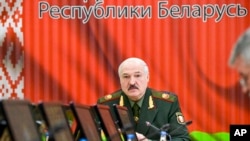 FILE: Belarusian President Alexander Lukashenko attends a meeting with top level military officials in Minsk, Belarus, on Nov. 22, 2021.