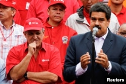 FILE -- Venezuela's Oil Minister and President of the Venezuelan state oil company PDVSA, Eulogio del Pino stands next to Venezuela's President Nicolas Maduro during a pro-government rally with workers of state-run oil company PDVSA in Caracas, Venezuela,