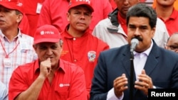 ລັດຖະມົນຕີນໍ້າມັນ ເວເນຊູເອລາ ແລະປະທານ ບໍລິສັດລັດວິສະຫະກິດ ເວເນຊູເອລາ PDVSA, Eulogio del Pino ຢືນຢູ່ຂ້າງປະທານາທິບໍດີ ເວເນຊູເອລາ ທ່ານ Nicolas Maduro. 