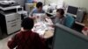 North Korean defectors, working for FreeNK newspaper in South Korea, wrap editions of paper in plastic, ready for the air drop. (Photo: FreeNK) 