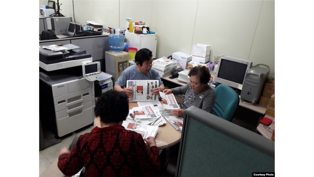 North Korean defectors, working for FreeNK newspaper in South Korea, wrap editions of paper in plastic, ready for the air drop. (Photo: FreeNK)