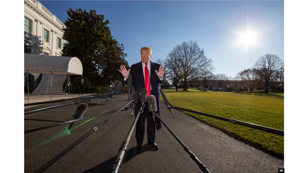 President Donald Trump speaks on the South Lawn of the White House as he walks to Marine One, Jan. 6, 2019, in Washington.