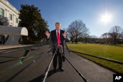President Donald Trump speaks on the South Lawn of the White House as he walks to Marine One, Jan. 6, 2019, in Washington.