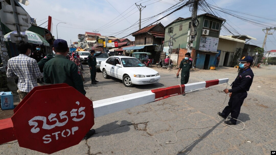 Local police officers stand guard at a blocked street near Phnom Penh International airport in Phnom Penh, Cambodia, April 15, 2021 as the country’s capital will be locked down for two weeks from following a sharp rise in COVID-19 cases.
