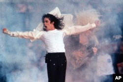 FILE - This Feb. 1, 1993 file photo shows Pop superstar Michael Jackson performing during the halftime show at the Super Bowl in Pasadena, Calif. (AP Photo/Rusty Kennedy)