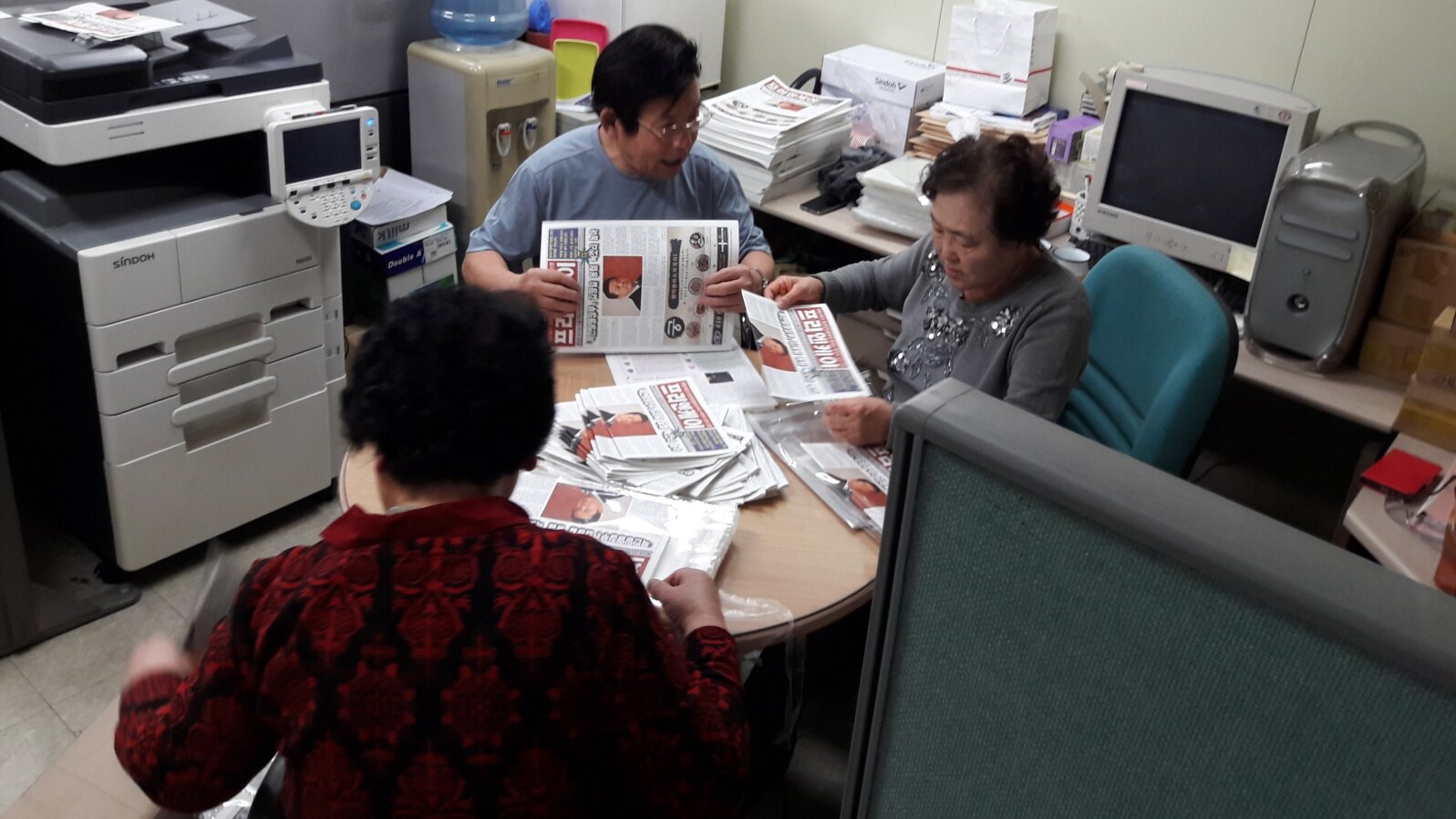 North Korean defectors, working for FreeNK newspaper in South Korea, wrap editions of paper in plastic, ready for the air drop. (Photo: FreeNK) 