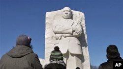 Visitors gather at the Martin Luther King, Jr. Memorial for a National Park Service wreath laying ceremony at the monument of the civil rights leader in observance of his of 83rd birthday-anniversary, in Washington, January 15, 2012.