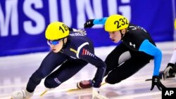 FILE - South Korea's Noh Jin-Kyu, left, speeds on track during the men's 1500 meters quarterfinal at the Short Track World Cup, in Turin, Italy.