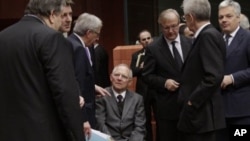 From left, Greek Finance Minister Venizelos, French Finance Minister Baroin, Luxembourg's PM Juncker, German Finance Minister Schaeuble, European Commissioner for the Economy Olli Rehn, Italian PM and Finance Minister Mario Monti and Belgium's Finance Min