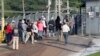 Workers exit a Koch Foods Inc. processing plant as U.S. immigration officials conducted a raid in Morton, Miss., Aug. 7, 2019.