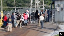 Workers exit a Koch Foods Inc. processing plant as U.S. immigration officials conducted a raid in Morton, Miss., Aug. 7, 2019.