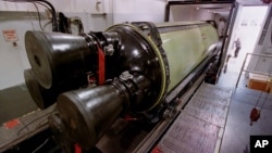 FILE - A Minuteman III missile engine is loaded into a truck for transport to another building for X-raying before being torn down and rebuilt at Hill Air Force Base, Utah. 