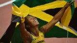 Jamaica's Shelly-Ann Fraser-Pryce celebrates after winning the women's 100m final at the athletics event of the London 2012 Olympic Games on August 4, 2012 in London. 
