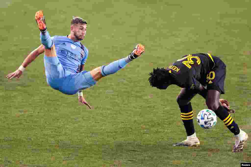 New York City FC midfielder Valentin Castellanos (11) falls after battling Columbus Crew defender Aboubacar Keita (30) for a high ball during the second half at Red Bull Arena in New York, Aug. 24, 2020. (Vincent Carchietta, USA Today Sports)
