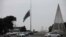 An Azeri state flag flies at half-mast as the country observes the day of national mourning for the victims of an Azerbaijan Airlines' Embraer passenger plane crash near the Kazakh city of Aktau, in a square in Baku, Dec. 26, 2024. 